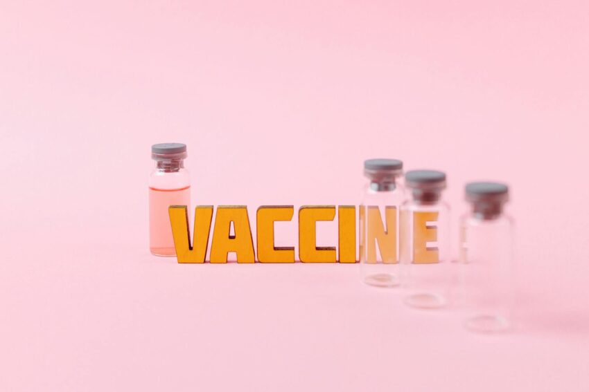 vaccine text beside empty clear glass vials